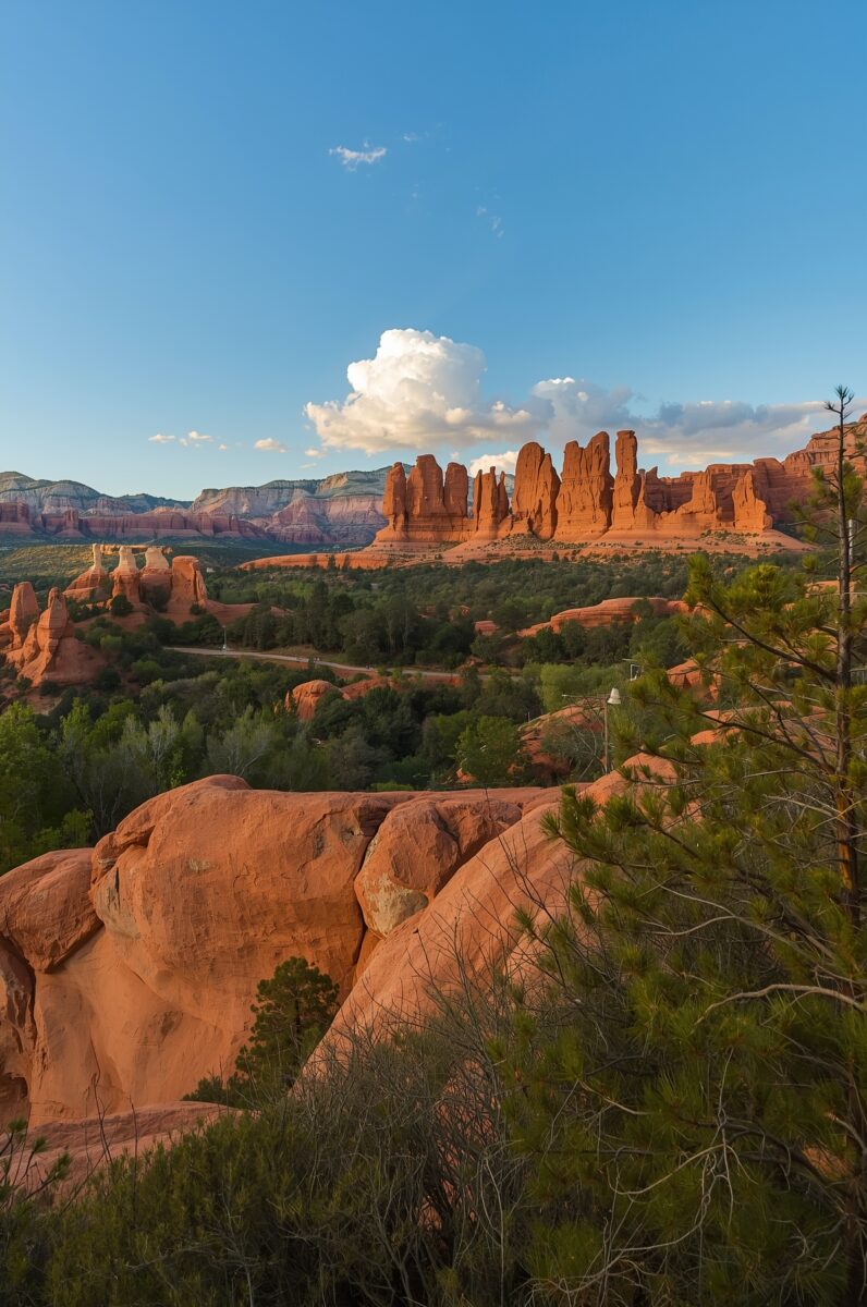 Red rock formations and desert landscape of Sedona Arizona with green trees and blue sky