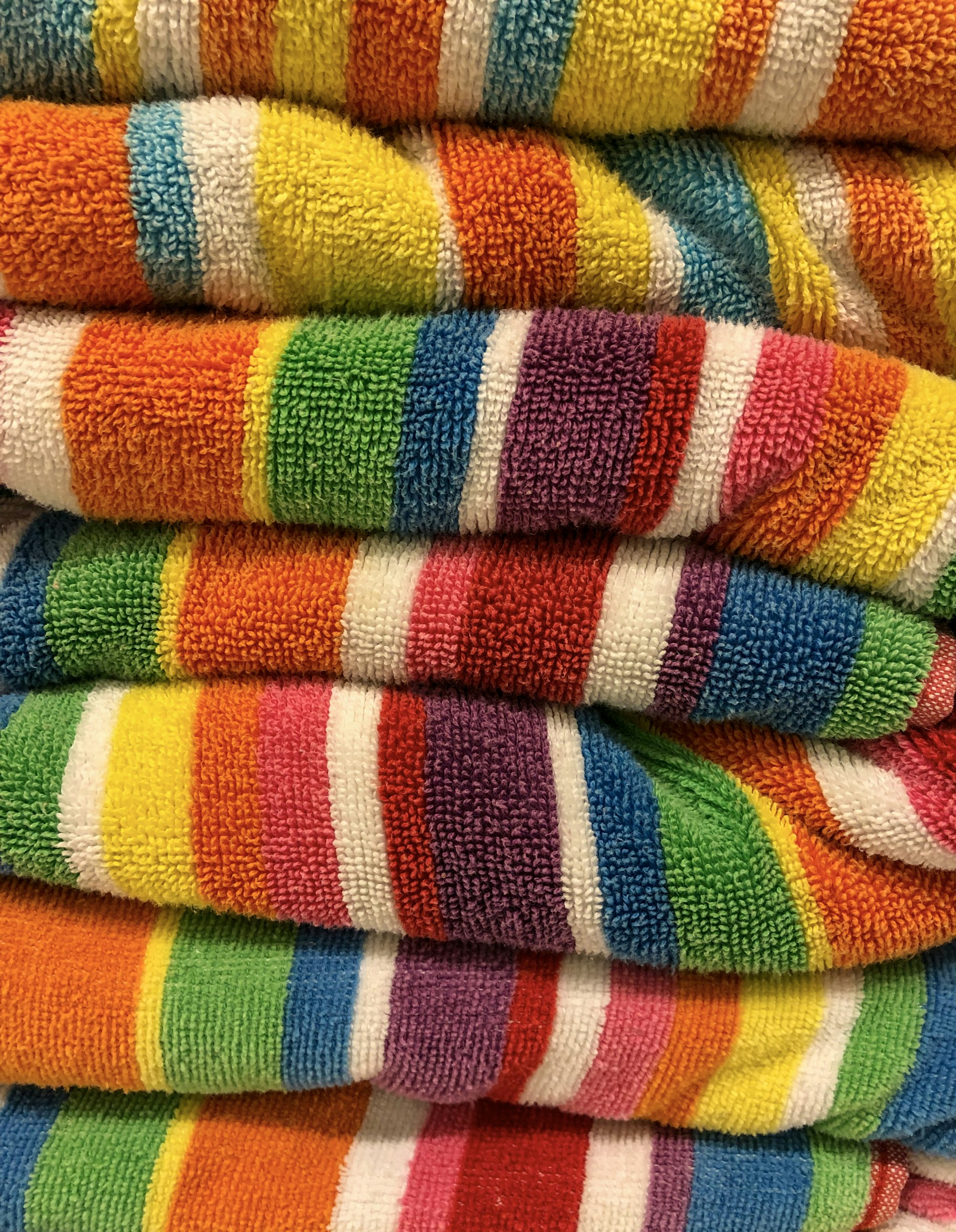 A close-up stack of thick striped terry towels